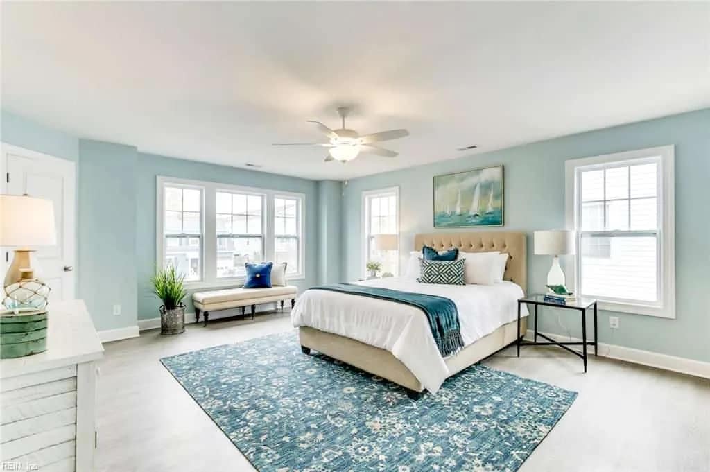 Airbnb bedroom staged with teal and blue accents, bright natural light, and guest-ready bedding