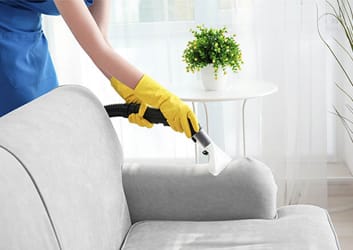 Spotless modern bedroom with natural light, freshly made bed, and clean floors in Cary NC home